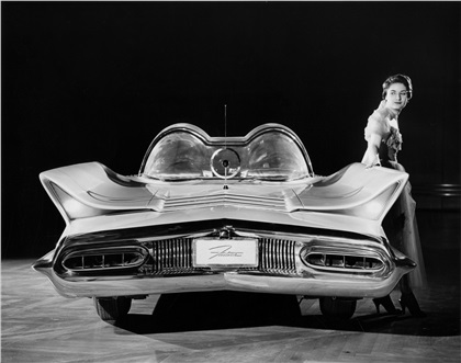 The Lincoln Futura -- called the most revolutionary and advanced vehicle ever to be driven on public highways -- all but stopped Manhattan traffic when it was given its driving premier in New York City. This full rear view shows the Futura's 'shark-fin' rear fenders which house the tail lights and its circular radio aerial, combined with an 'audio approach' microphone designed to pick up and amplify the sound or horn signal from any car approaching from behind.