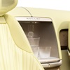 Interior view of Cadillac SOLLEI concept vehicle with Sunburst Motif pattern seats and crystal glass accessory inside integrated beverage chiller