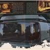 The nocturnal view — through the rear window — shows the expandable bathroom wall. Atop is the sun deck; when traveling, a bubble of air arches over the space so that the deck can be open. Obviously, the couple pictured here couldn't care less about all of this.