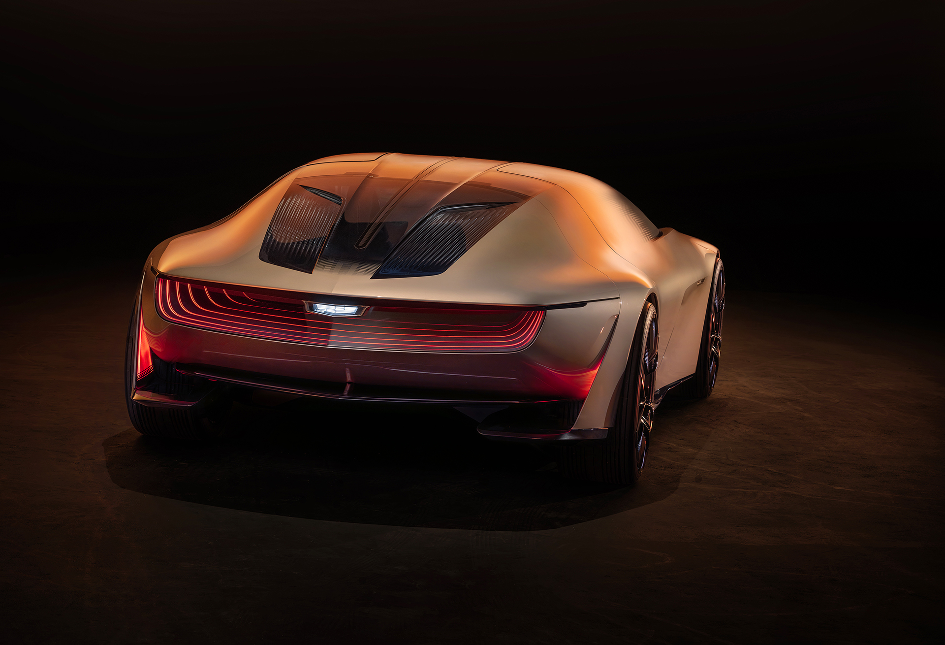 Rear view of Cadillac Opulent Velocity concept vehicle in Gilded Pearl exterior color.