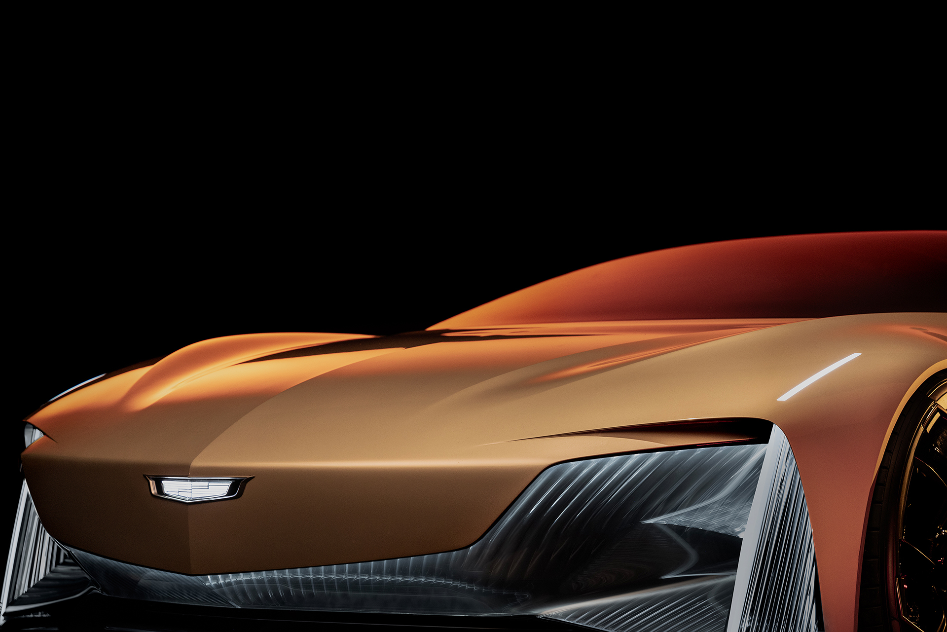 Close-up view of Cadillac Opulent Velocity concept vehicle’s dramatic draped front fascia in Gilded Pearl exterior color.